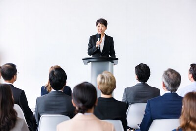 Asian woman speaking at podium