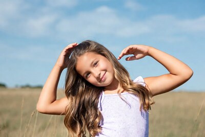 Young girl posing in field