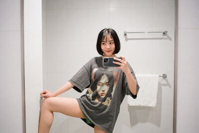 Young woman taking mirror selfie