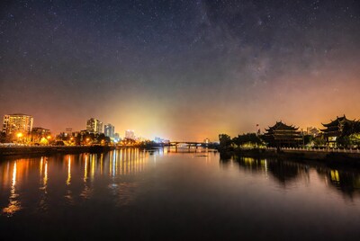 Night cityscape with river and stars
