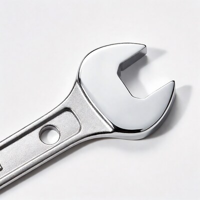Shiny metal wrench on white background