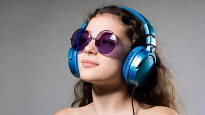 Woman wearing blue headphones and sunglasses
