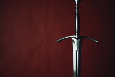 Medieval sword on red background