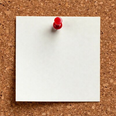 Blank note pinned to corkboard