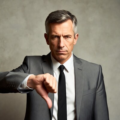 Businessman giving thumbs down
