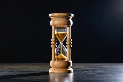 Wooden hourglass with flowing sand