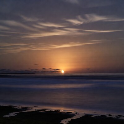 Sunset over calm ocean horizon