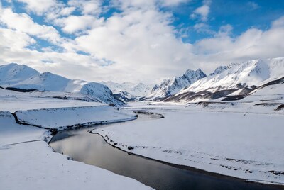 Snowy river winding through mountains