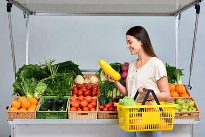 Woman Holding Yellow Squash at Market