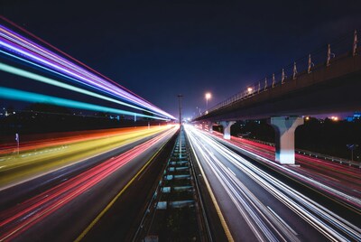 Night highway with colorful light trails