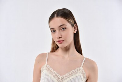 Young woman in white lace top