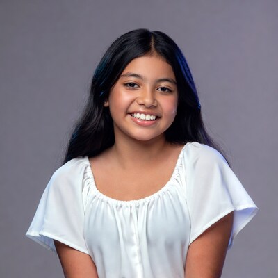 Young girl smiling in white top
