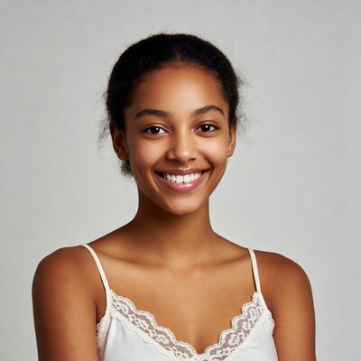 Young woman smiling in white top
