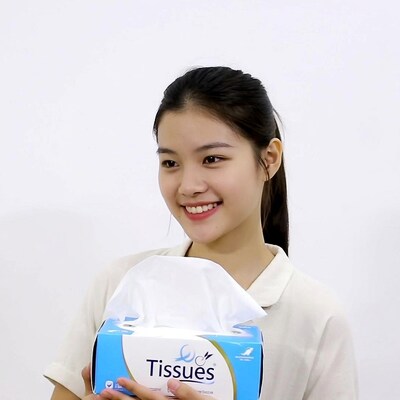 Young woman holding tissue box