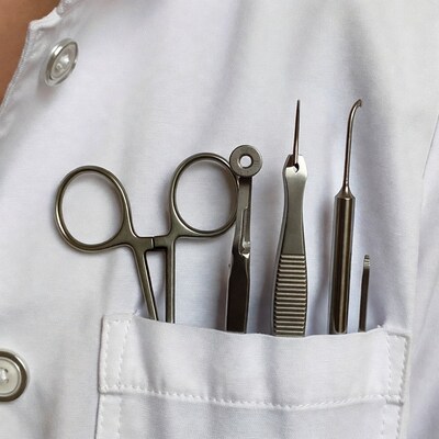 Surgical tools in white coat pocket