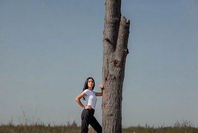 Woman leaning against tree