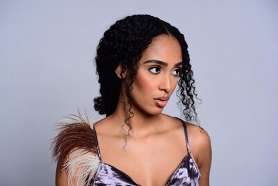 Woman with curly hair and feather