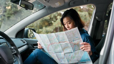 Woman reading map in car