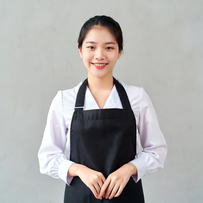Asian woman in black apron