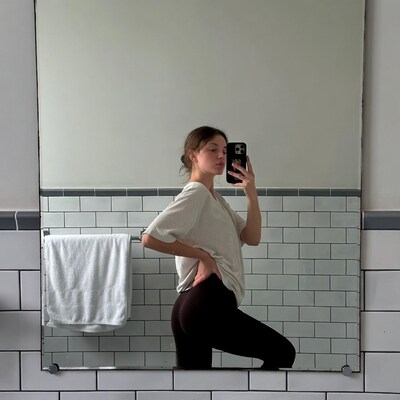 Woman taking mirror selfie in bathroom
