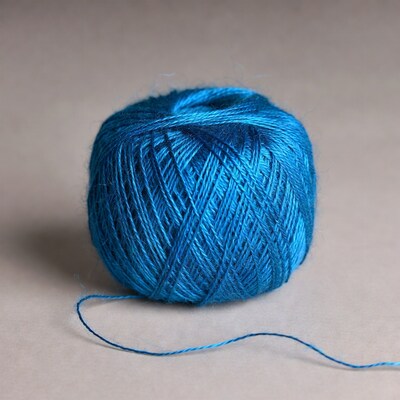Blue yarn ball on neutral background
