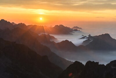 Sunrise over misty mountain peaks