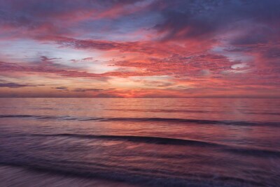 Ocean sunset with pink clouds