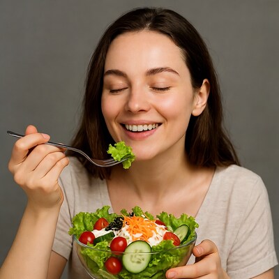 Woman eating fresh salad