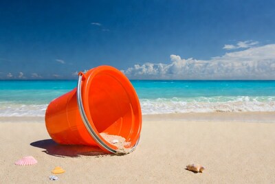 Orange bucket on beach