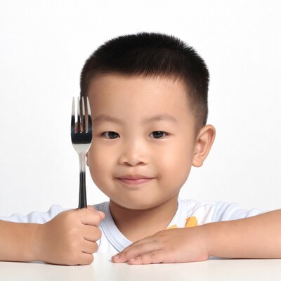 Asian boy holding fork