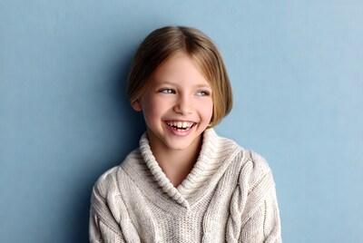 Young girl smiling in sweater