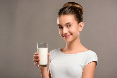 Young woman holding glass of milk