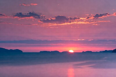 Sunset over calm ocean water