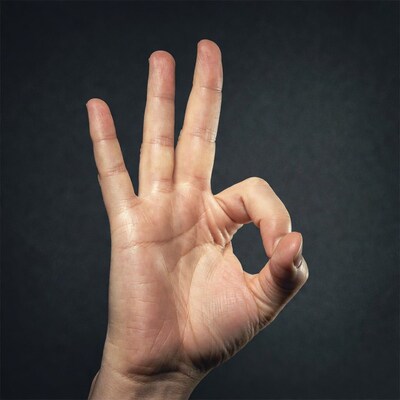 Hand making OK gesture