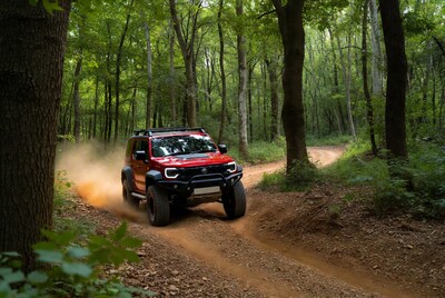 Red SUV driving on forest trail