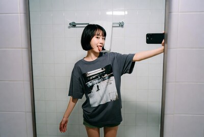 Young woman taking selfie in bathroom