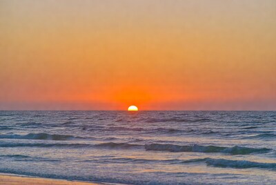 Sunset over ocean waves