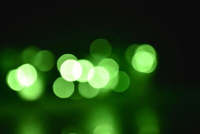 Green bokeh lights on black