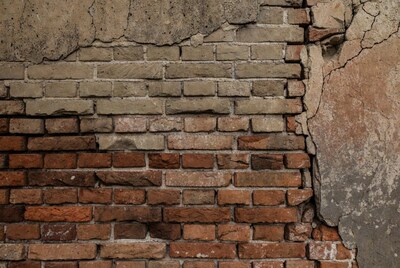 Old brick wall with plaster