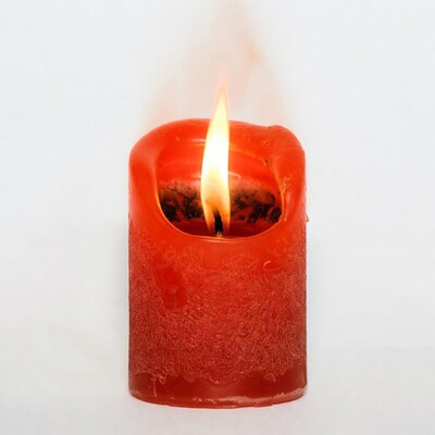 Lit red candle with flame