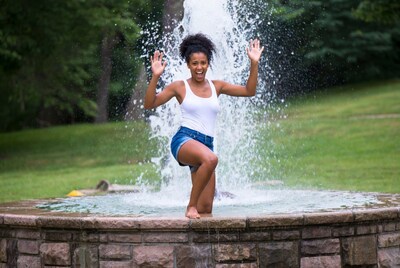 Woman posing in water fountain