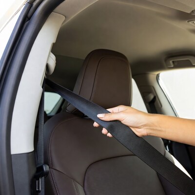 Hand pulling car seatbelt