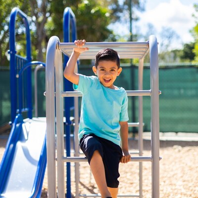 Boy climbing on playground bars
