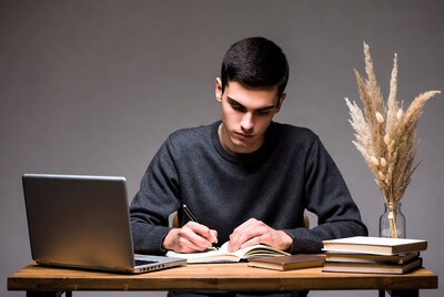 Young man studying with laptop