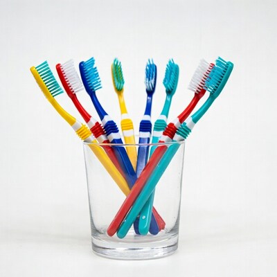 Colorful toothbrushes in glass cup