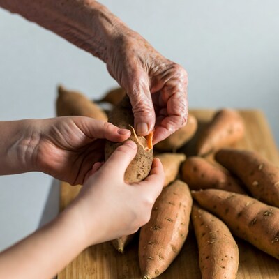 Elderly hands peeling sweet potato