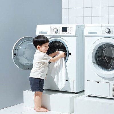 Boy putting towel in washing machine