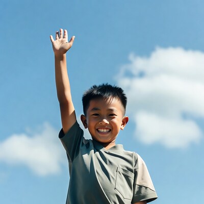 Asian boy waving hand