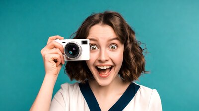 Excited woman holding camera