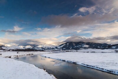 Snowy river valley with mountains